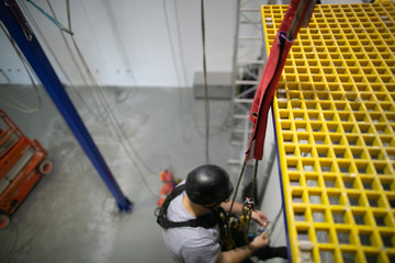 Safe work practices rope protection prevention on sharp edges with defocused rope access female...