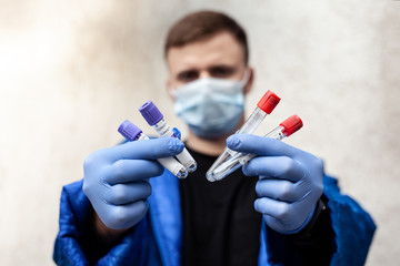 laboratory technician hold on blood sample tube for corona virus test , COVID 19 test