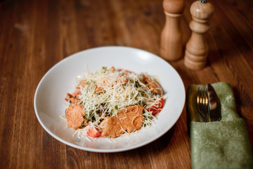 fresh caesar chiken salad on wooden table. photo for menu