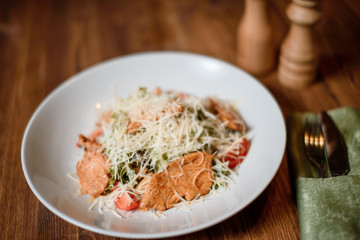 fresh caesar chiken salad on wooden table. photo for menu