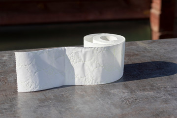 wooden background in retro style on it lined with pyrimide toilet paper