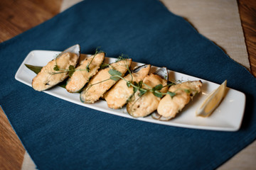 grilled mussels with cheese on table