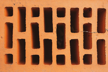 The texture of an orange brick. Close-up