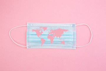 Concept. Disposable medical surgical face mask on white background, with world map superimposed on them. Protection against Covid-19 coronavirus outbreak