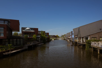 Fototapeta na wymiar Residential buildings in a peaceful neighboorhood, on the shore of a canal