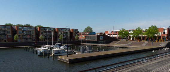 Almere, Netherlands - April 22 2019: Yacht marina in Almere, bordered by a modern pedestrian bridge