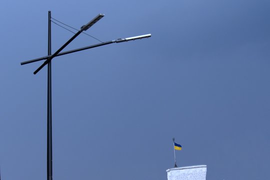 street lamp and the national flag of Ukraine in the background