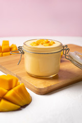 Mango yogurt on pink background