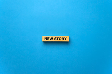 New story - phrase from wooden blocks with letters, Personal History Achievement Biography My story concept, blue background