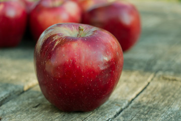 red apple on an old, worn garden table