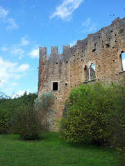 Fototapeta na wymiar Beautiful ruins of a Castle in Giardini di Ninfa, Italy