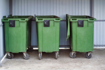 Green plastic trash recycling container.Green containers for collecting garbage on the dustbin.