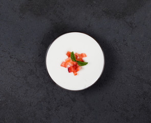 Italian dessert Panna cotta vanilla with strawberries in a glass bowl on a dark background top view