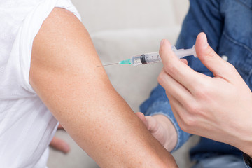 Person gets a vaccine in times of coronavirus
