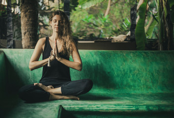 the Woman meditating with namaste