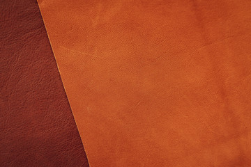 Brown and tan leather samples close-up, abstract background, texture. Shopping and industry concept