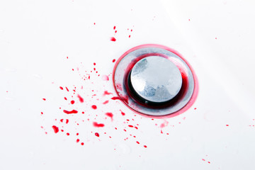 Blood in a white sink, water, top view
