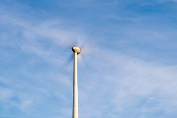 Wind turbine with fast moving propellers (long exposure photo)