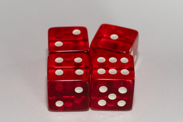 4 red casino dice on a white background