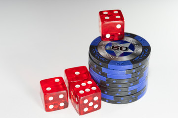 4 red casino dice and chips with a face value of 50 on a white background