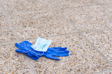 Medical gloves and surgical mask lying on the floor