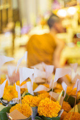 Yellow flowers that Buddhists bring to pay respect to monks