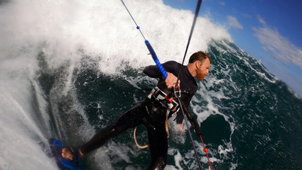 kitesurfer going deep into the pocket of the wave