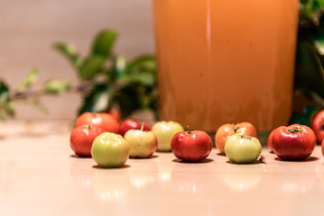 Acerola juice (Malpighia emarginata) on light and woody background