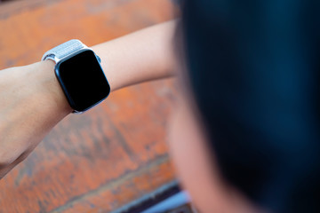 using her smart watch app. Closeup hands