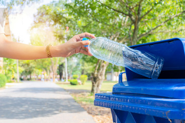 Close up hand throwing empty plastic bottle