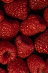 Close-up of berries (blueberries, raspberries) on a dark background.