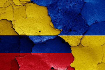 flags of Colombia and Ukraine painted on cracked wall