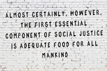 Painted black mindful inscription on white brick wall background