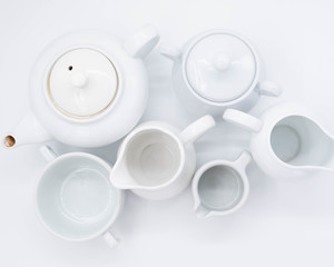 cup with tea and teapot on white background, over light
