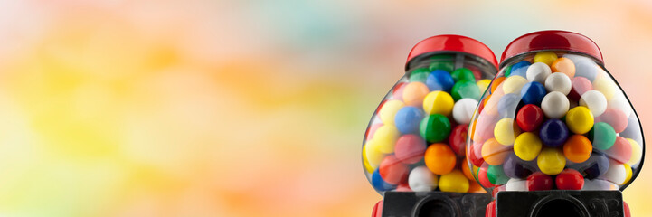Coin Operated Gumball Machines isolated on colorful background