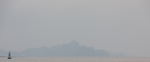 Misty hills of Cat Ba island during foggy day