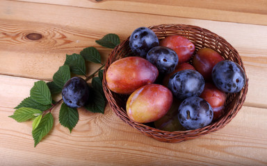 Different color plums on table
