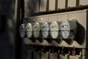Apartment electricity meters on a sunny spring evening.