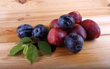 Different color plums on table
