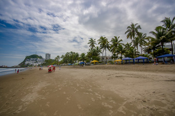 Fototapeta premium Beautiful view of the beach with sand, and buildings behind in a beautiful day in with sunny weather in a blue sky in Same, Ecuador