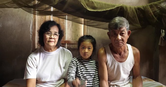 Senior Couple And Granddaughter Watching  Tv
