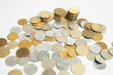 Coins stacked in small towers - Coins isolated from white background - Pile of queztales currency of Guatemala