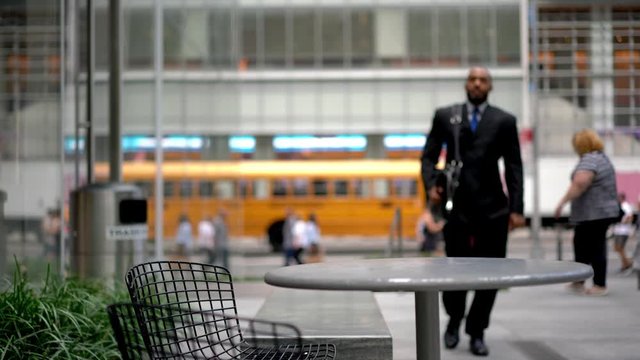 African American male person appointed to act for customer in business or legal matters seating at table in street cafeteria for working with public information using laptop for research evidence
