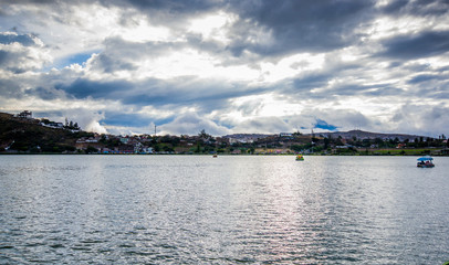 Obraz premium View of the Yahuarcocha lake, with a panoramic view of the city in the horizont in Yahuarcocha Ecuador