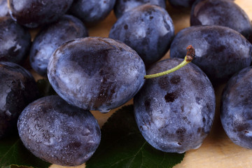 Black plums on table