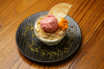 Fruit sorbet decorated with edible flower served at restaurant table
