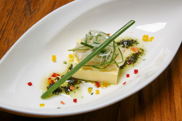 Tofu steak with salsa verde sauce. Exquisite dish, creative restaurant meal concept, haute couture vegan food