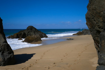 Fototapeta na wymiar Footprints and solitude in walking along the sandy beach 