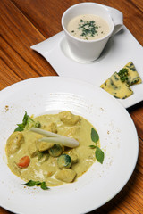 Stew chicken curry in coconut sauce and creamy vegetable soup served on the restaurant table