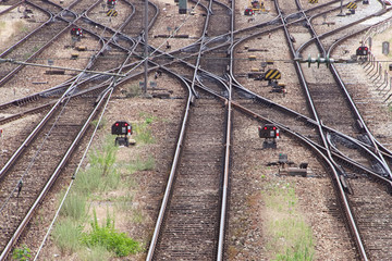 Many railway lines are shown crossing outside a train depot yard.